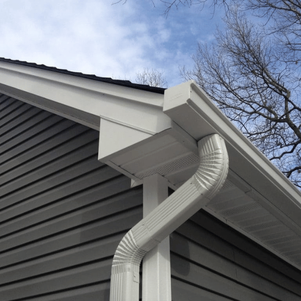 White seamless gutter system installed on a residential home, blending with the roofline for efficient water flow.